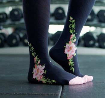 Model wearing the black socks with pink floral print