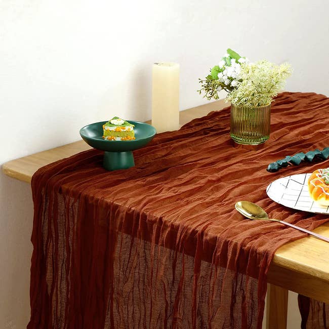thin tablecloth over wood table