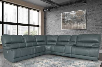 lifestyle photo of teal L-shaped reclining sectional sofa
