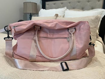 reviewer photo of pink duffel bag