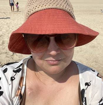 Reviewer wearing coral and straw crochet hat