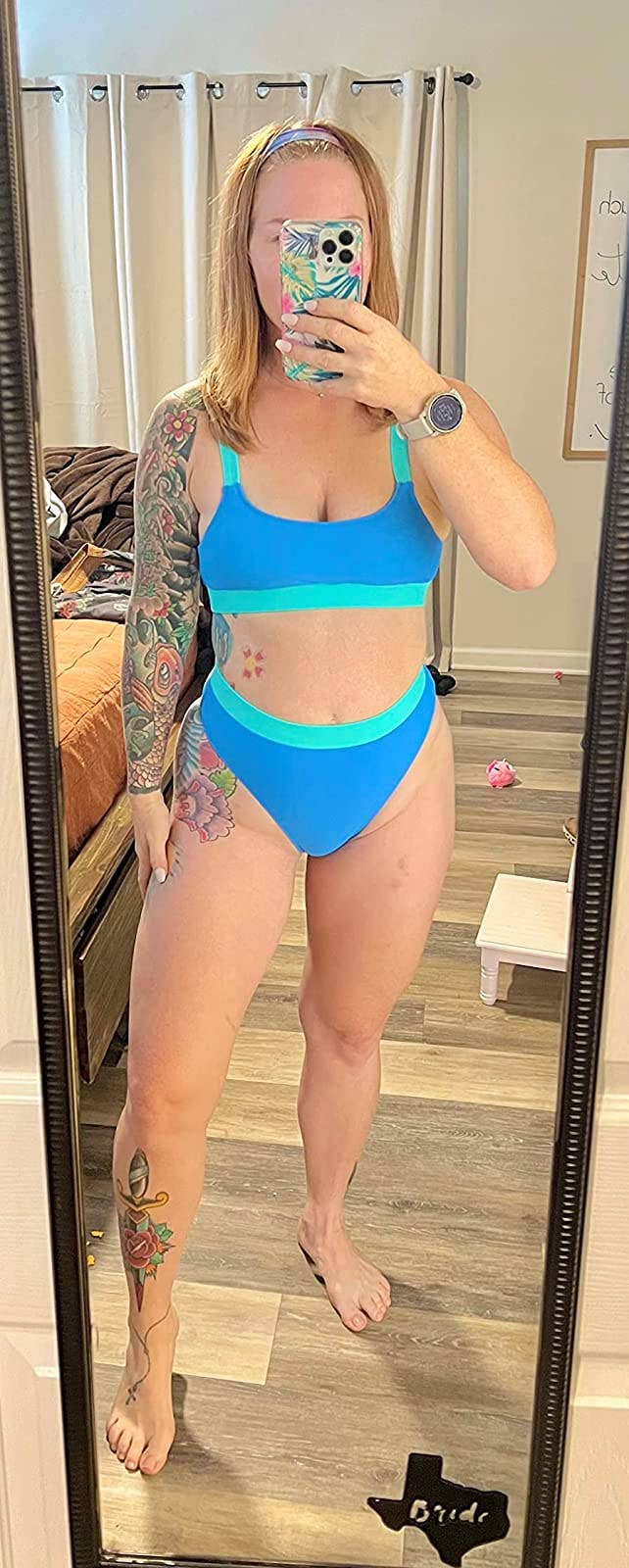 reviewer wearing blue and green color block swimsuit