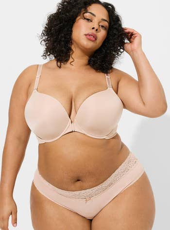 Model posing in beige front-closure bra