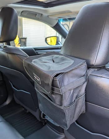 Back seat of a car showing a trash can