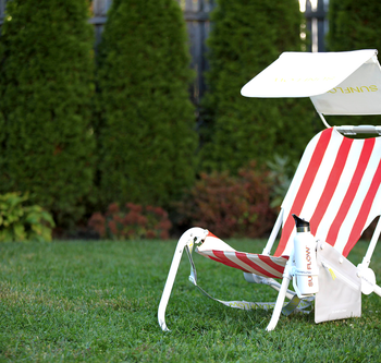 the red striped chair and beach bundle accessories set up in a yard