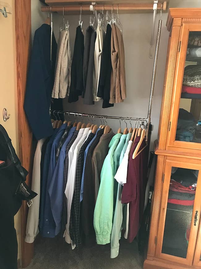A customer review photo of the Simple Houseware adjustable closet hanging rod in chrome hanging in their closet
