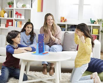 Family playing Connect 4 Spin Game