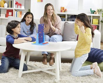 Family playing Connect 4 Spin Game