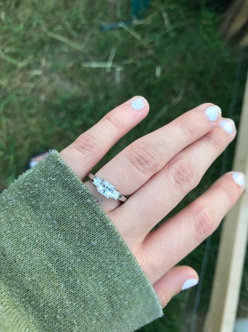a reviewer wearing the three stone ring