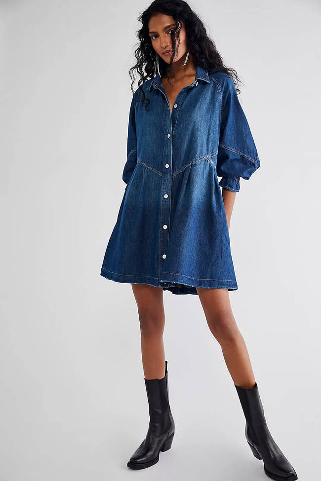 Model in button up denim midi dress with 3/4 length sleeves 