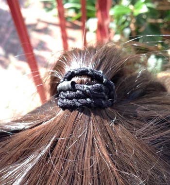 the hair tie in a reviewer's hair holding a ponytail