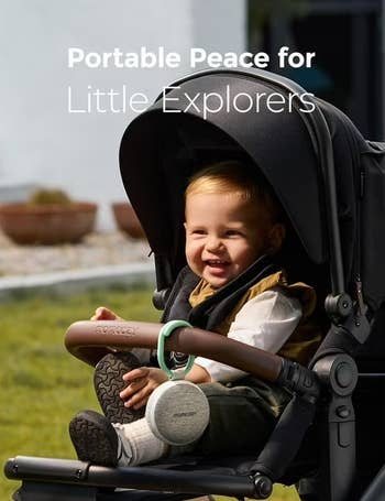 Child smiling successful  a stroller with the substance   