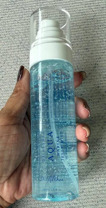 A idiosyncratic   holds a vessel  of Dr. Althea Aqua Marine Jelly Mist, a skincare merchandise  designed for hydration