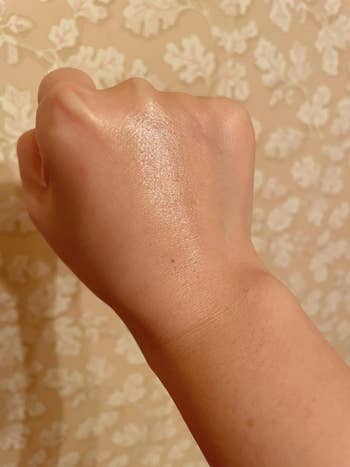 Swatch of the balm on back of a hand leaving the skin appearing hydrated and dewy