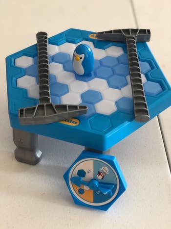 A closeup of the toy assembled with the penguin and two toy ice picks on top