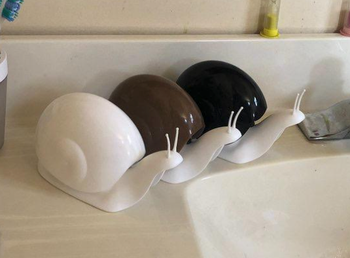 Reviewer image of white, brown, and black snail soap dispensers