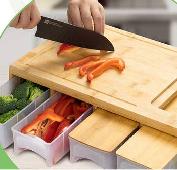Model chopping peppers on a wooden cutting board with four pull out storage compartments under it 