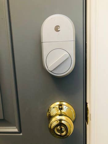 The smart lock installed on a front door