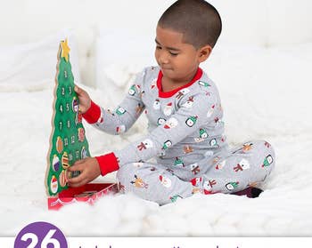 a child playing with a magnetic christmas-tree shaped advent calendar
