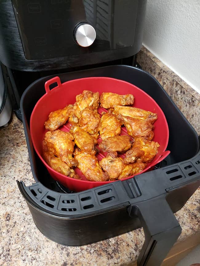 The red silicone basket in an air fryer