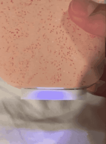 Hand holding a smart soap dispenser releasing foam onto a white surface, demonstrating a touch-free feature for a home shopping article