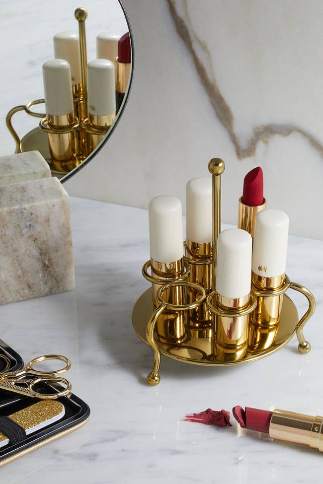 the gold lipstick holder with five lipsticks
