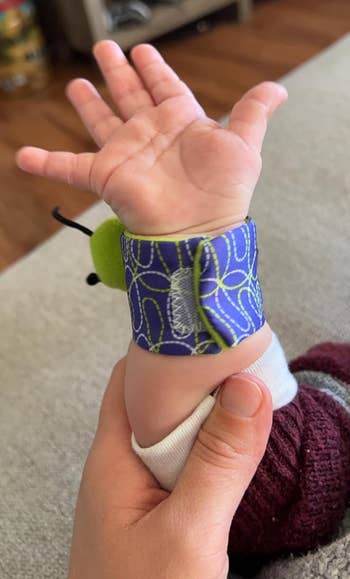 image of reviewer's baby wearing the rattle wristband