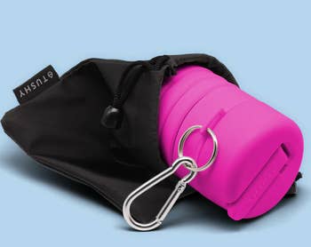 A Tushy in pink in a black pouch