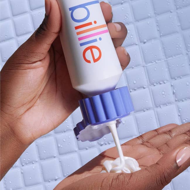 Hand dispensing Billie shaving pick onto thenar implicit a tiled background