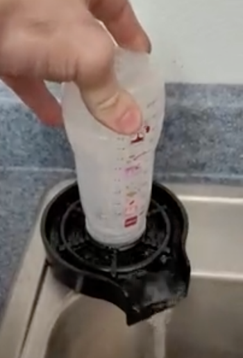 Reviewer washing a baby bottle 