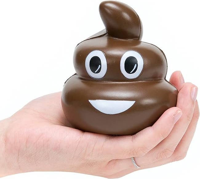 hand holding a stress ball shaped like a pile of poop