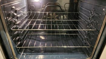 same reviewer's photo of the sparkling-clean inside of the oven after using the oven cleaner
