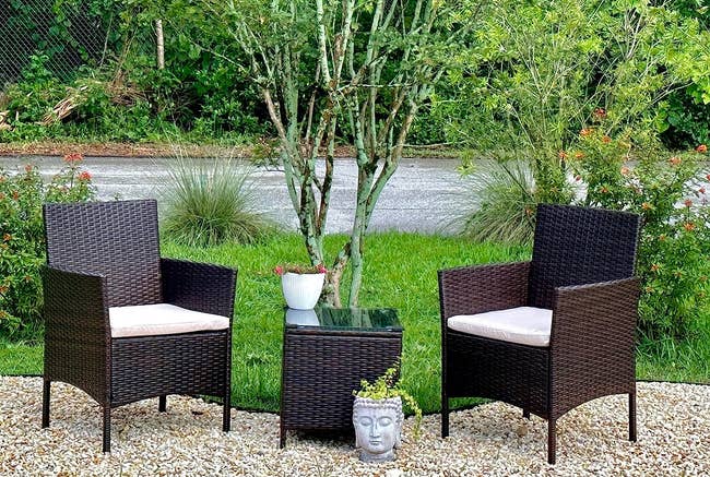 Two wicker chairs and a tiny array betwixt them