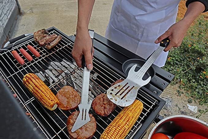 model using the guitar utensils with food on a grill