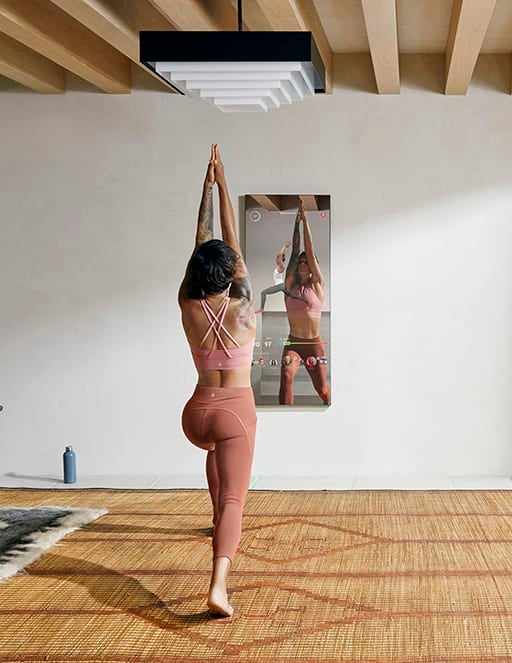 a model using the mirror to stretch