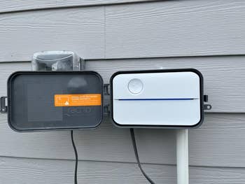 reviewer image of the Rachio installed on the exterior of a home's siding