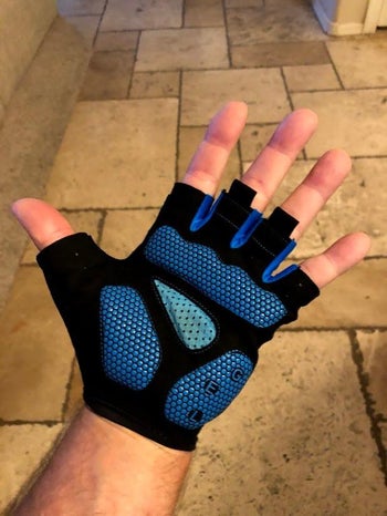 reviewer photo of palm, wearing green and black open finger bike gloves