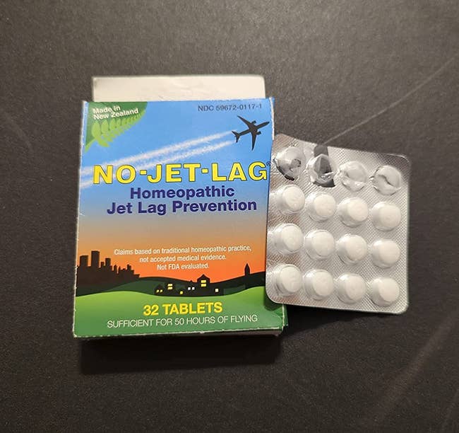 reviewer photo of a pack of jet lag tablets next to their box