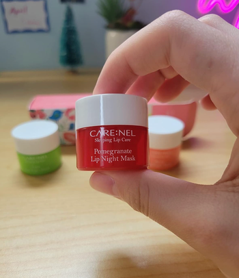 reviewer holding small pomegranate lip mask 