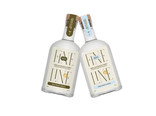 Two bottles of Fine Line non-alcoholic spirits, zero impervious tequila and vodka, tilted towards each different against a plain background