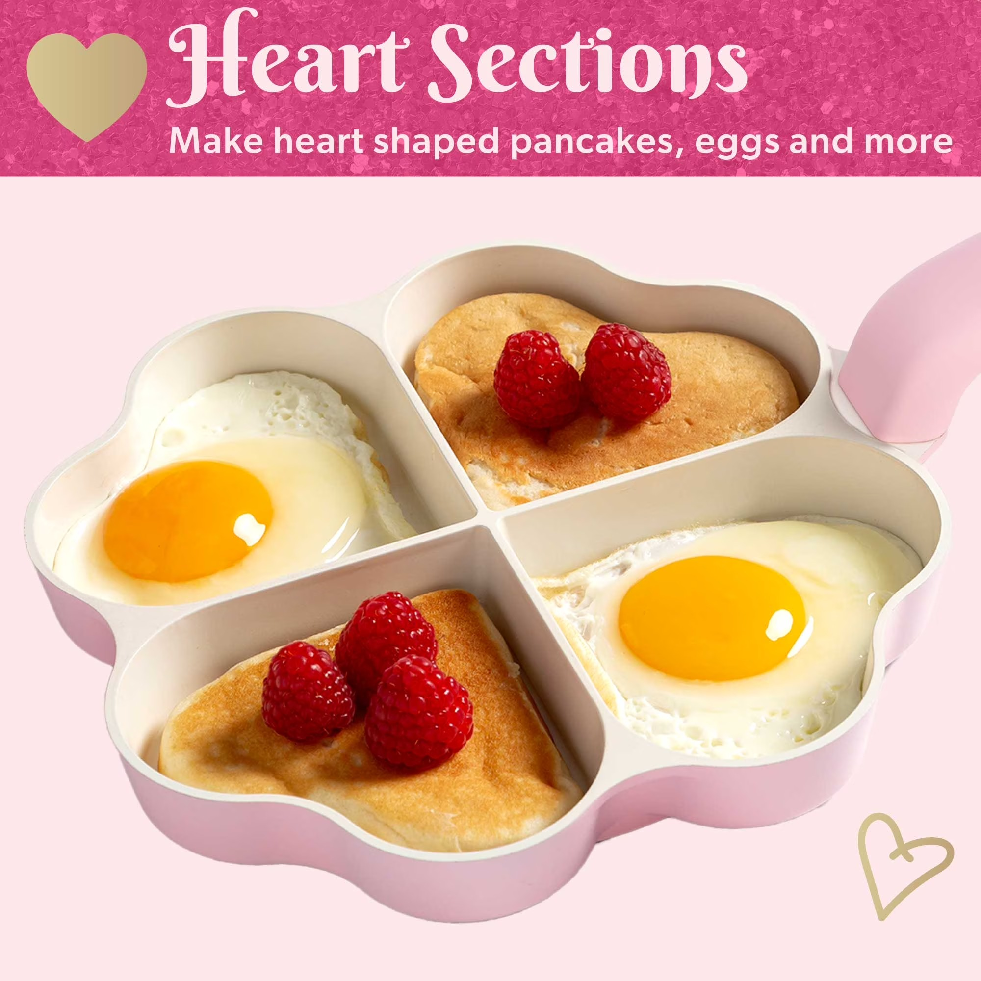 Pink heart-shaped silicone mold with sections for making pancakes and eggs, shown with pancakes, eggs, and raspberries inside