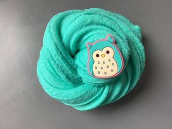 Soft, fluffy teal slime with a cute owl charm connected  top, perfect  for sensory play