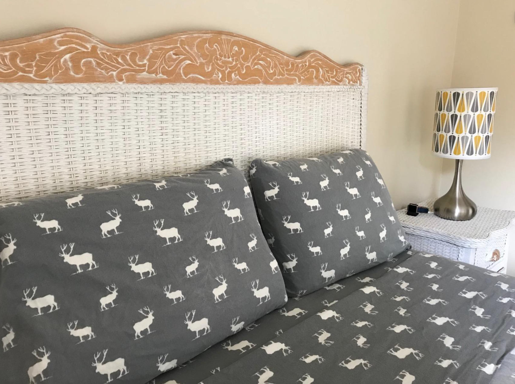 reviewer's bed with moose print flannel sheets on it