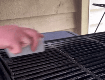 gif of someone cleaning a grill grate with the stone