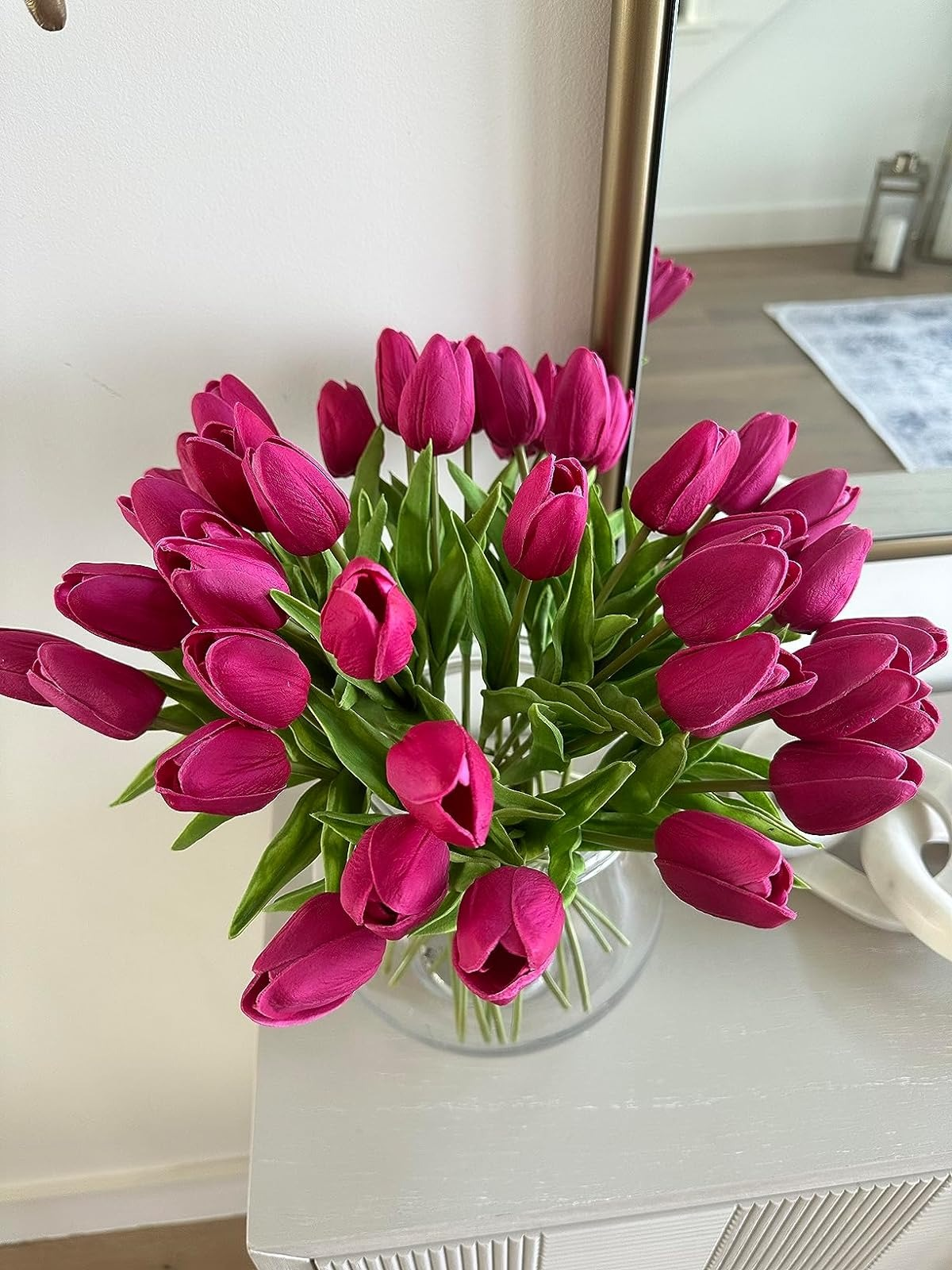 the reviewer's vase of hot pink silk flowers