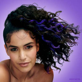 model with purple streaks in dark hair 