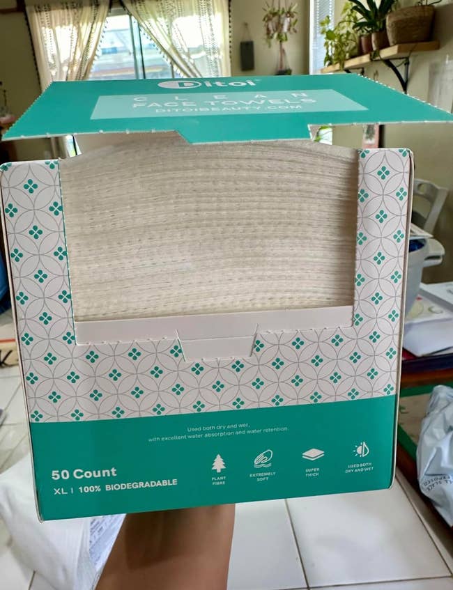 Open container  of 50 biodegradable insubstantial  towels, showcasing firmness and eco-friendly packaging, suitable for household   use