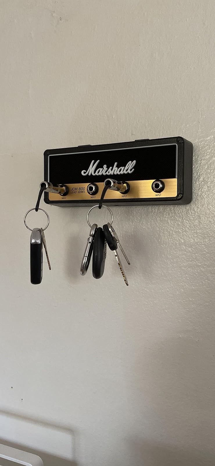 Key holder designed like a Marshall amplifier with keys hanging on metal jack plugs