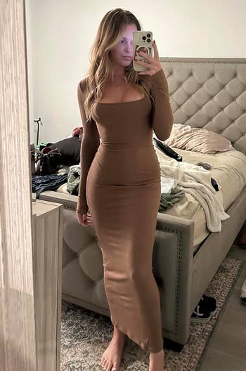 reviewer posing successful agelong brownish dress
