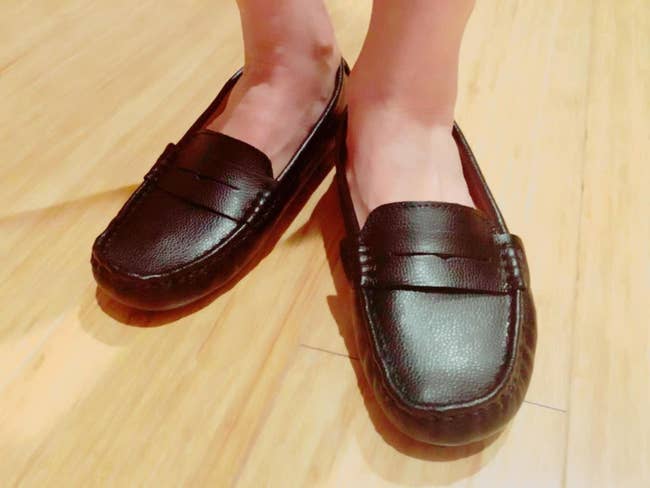 Close up of reviewer wearing the round toe loafer in black